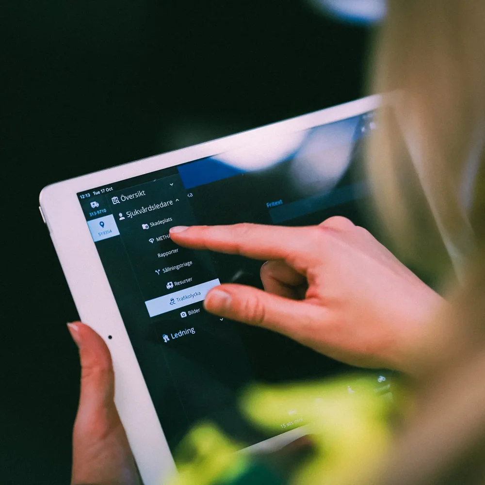 Ambulance worker interacts with MobiMed ePR on touch screen ios