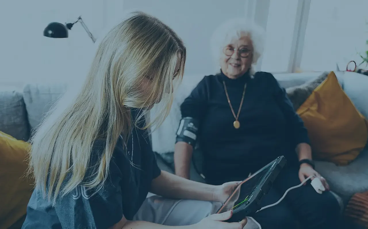 paramedic checking old womans values>