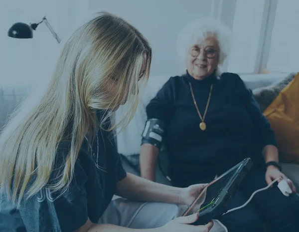 paramedic checking old womans values
